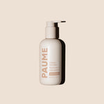 PAUME probiotic hand balm bottle on a beige background