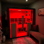 Infrared sauna in a dimly lit room with red light