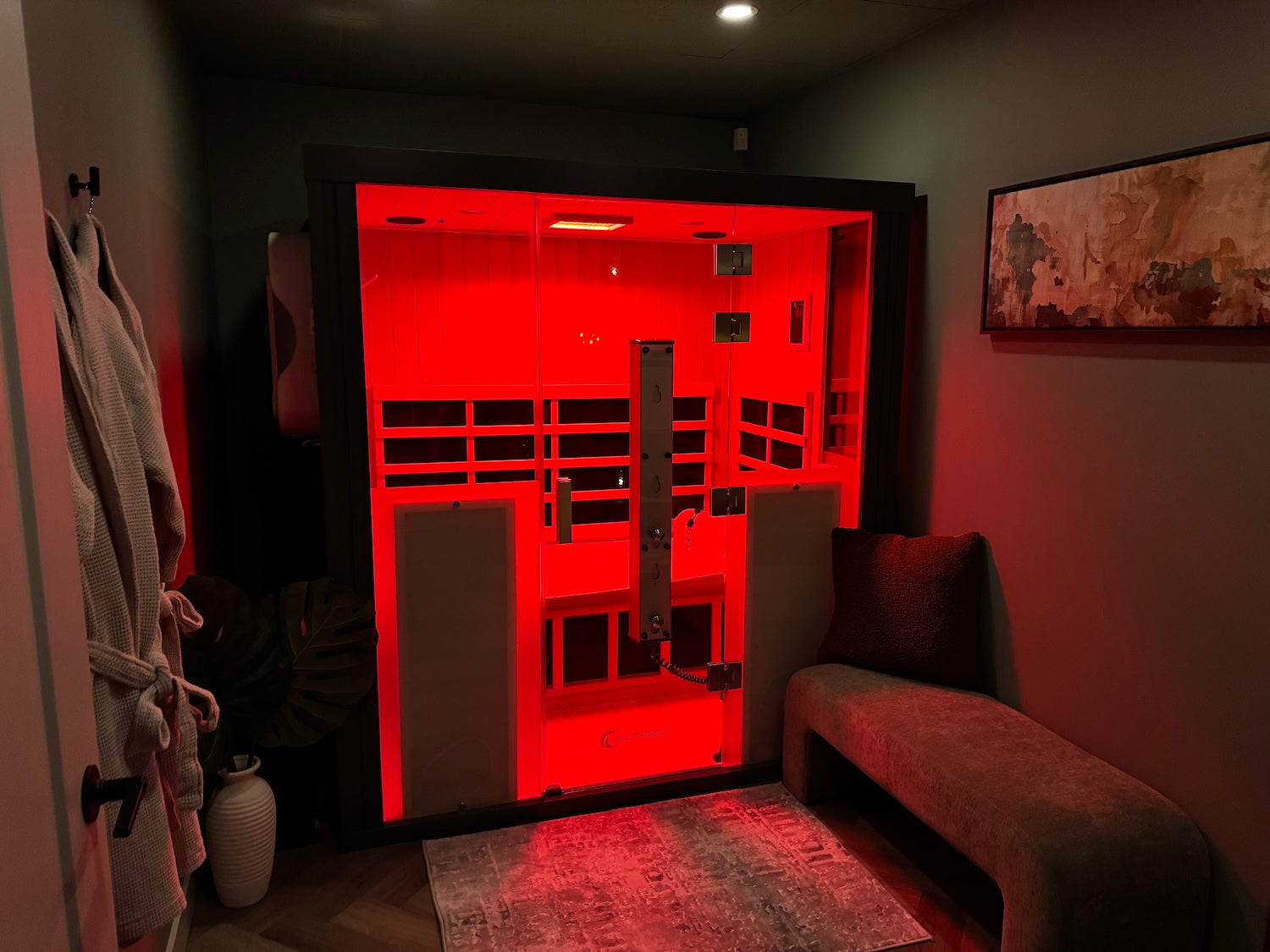 Infrared sauna in a dimly lit room with red light